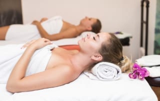 A pair of women relaxes at the spa during their wellness retreat in the Texas Hill Country.