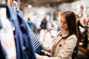 A young woman peruses one of the many clothing shops in Fredericksburg TX.