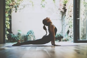 A female yoga enthusiast practices her poses during a wellness retreat in the Texas Hill Country.