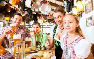 Family of four enjoys a Bavarian-themed dinner at a German restaurant in historic Fredericksburg, TX.