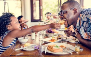 A child and dad share a sweet moment at brunch in Fredericksburg, TX.